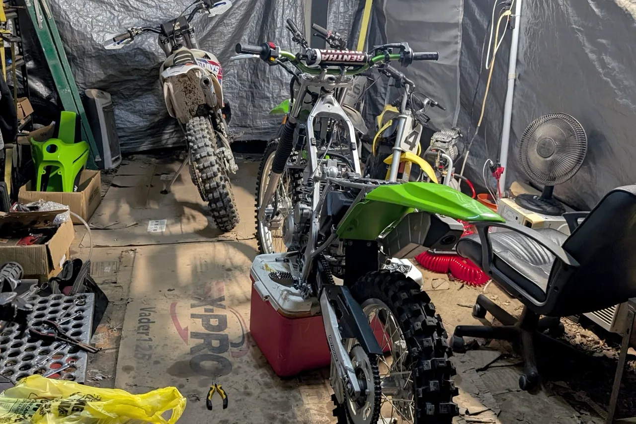 Inside my shop tent, dirt bikes up on stands